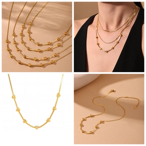 Detail view of 18K gold plated heart pendant necklace set with layered chains