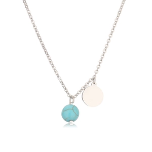 Macro detail of turquoise sphere pendant and polished silver disc on stainless necklace