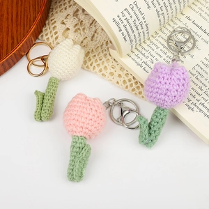 Handmade crochet tulip flower keychains in white, pink and purple yarn with metal rings