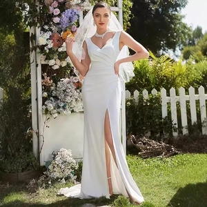 Elegant white satin wedding dress with V-neck sleeveless design and high slit in garden