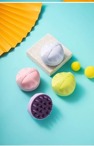 Detail of four colorful silicone scalp massage brushes with soft conical bristles