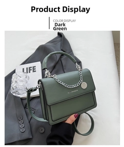 Detail view of dark green square chain bag with silver buckle and fashion lettering