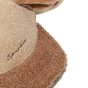 Detailed view of beige and brown sherpa baseball cap with sparkle embroidery