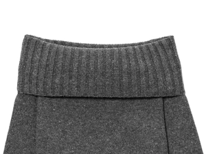 Detail of dark grey knit fabric showing ribbed texture and fine stitching on the top