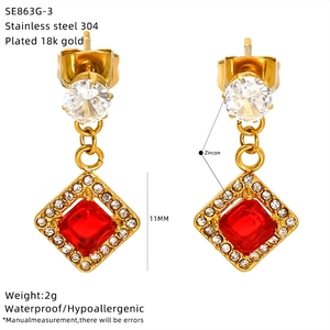 Detail view of square gold stud earrings with red zircon and technical specifications