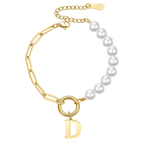Close-up of pearl and link chain bracelet with a gold D pendant and 18KGP mark