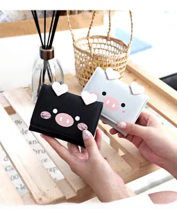 Close-up of cute cartoon pig short tri-fold wallets in black and grey soft PU leather