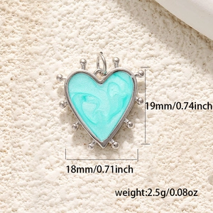 Detailed size view of turquoise enamel heart pendant with silver beaded edges