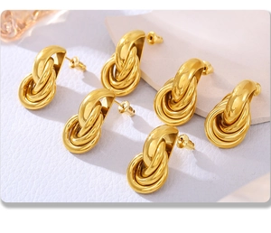 Detail view of 18K gold plated stainless steel interlocking triple circle knot earrings