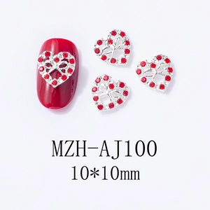 Macro detail of 10mm red rhinestone heart nail charms with silver alloy bow base