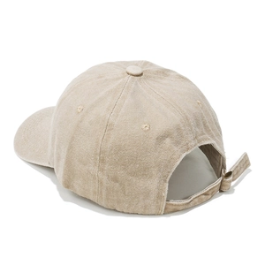 Detail view of adjustable metal buckle and strap on beige washed cotton baseball cap