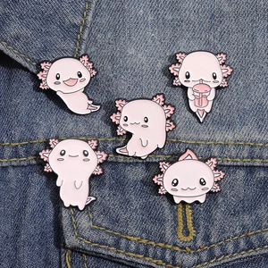 Set of five cute pink axolotl enamel pins on a blue denim jacket pocket