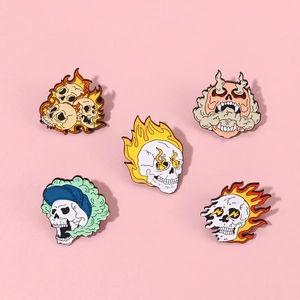 Five unique punk skull enamel pins set with flame and hat designs on pink background