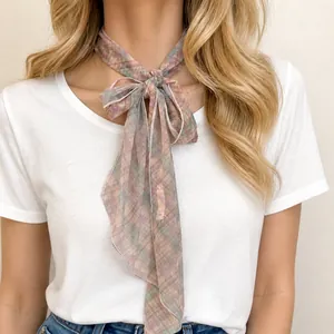 Vintage floral print fabric scarf necklace worn as a bow tie accessory on a model