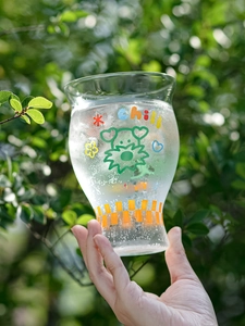 Close-up of high borosilicate glass with chill bear print and iced carbonated drink
