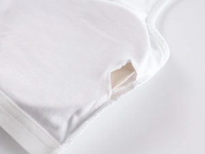 Detailed close-up of side padding pocket and fine knit texture on white sports vest