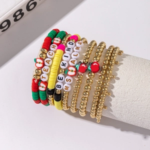 Detail of beaded bracelets with heart, apple charms and personalized teacher letters