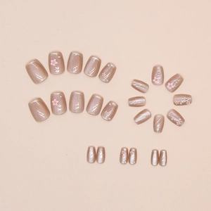 Detailed view of cat-eye press-on nails with 3D pink flowers and pearl decorations