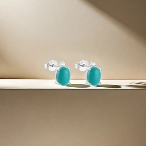 Detailed close-up of S925 silver turquoise flower moon studs with clear zircon accents