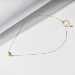 Detail of s925 silver gold necklace with oval green zircon and adjustable lobster clasp