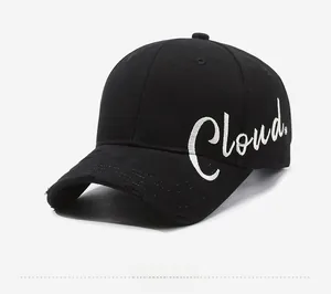 Detail of black cotton baseball cap with white Cloud embroidery and distressed brim