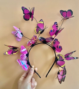 Detail of 3D colorful butterflies on a black headband for festive hair accessory style