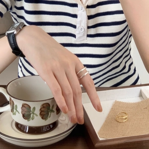 Detail of minimalist double-layered sterling silver ring in gold and silver finish