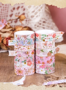 Detailed stack of floral washi tapes with pastel flower patterns for journaling