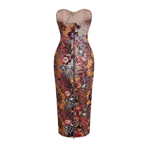 Detail of the back long zipper on a slim sequin dress with vibrant floral patterns