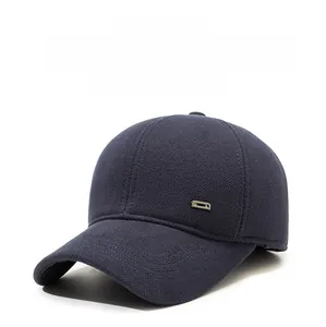 Close-up of navy blue winter baseball cap showing thick twill fabric and metal detail