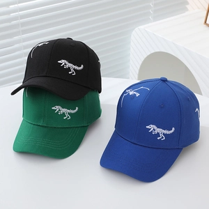 Close-up of white dinosaur skeleton embroidery on colorful cotton baseball caps