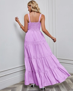 Back view of a purple striped maxi dress showing the adjustable shoulder straps and waist detail