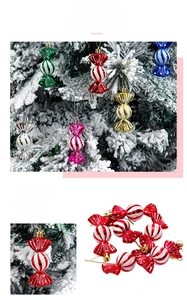 Detail of candy-shaped Christmas ornaments with glitter stripes and metallic finishes