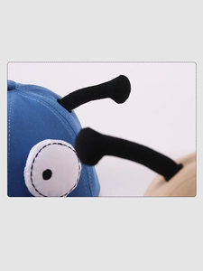 Close-up of baby cap featuring blue cotton fabric with cartoon eyes and 3D antennas