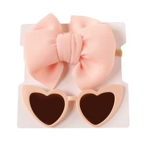 Pink bow headband and heart-shaped sunglasses set for baby girls on display card