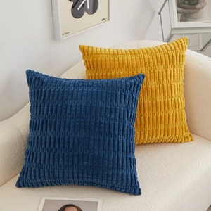 Plush corduroy texture square throw pillows in deep blue and mustard yellow on sofa
