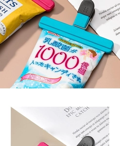 Close-up of T-shaped plastic food sealing clips in blue and red on snack bags