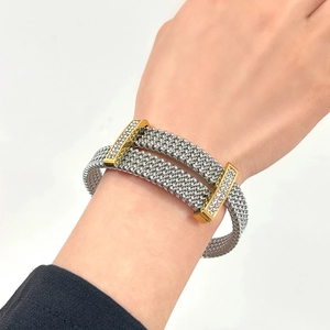 Mesh silver titanium steel cuff bracelet with gold zircon bar shown on person's wrist