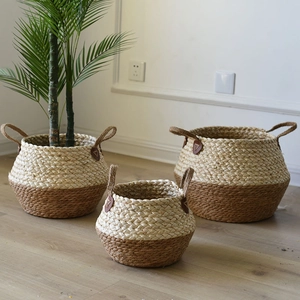 Set of three nesting seagrass baskets with dual-tone design and sturdy handles