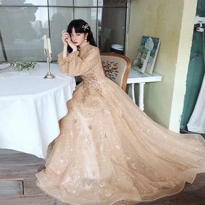 Elegant champagne gold long sleeve evening gown with star and moon sequin embroidery