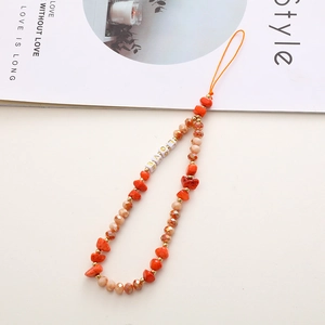Detail of handmade beaded phone strap with orange stones and LOVE letter beads
