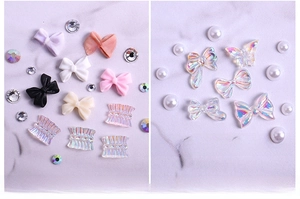Detail view of 3D aurora butterfly and resin bow nail charms in various colors