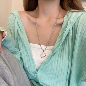 Detail of silver titanium steel necklace with Venus relief pendant on ball chain worn by model