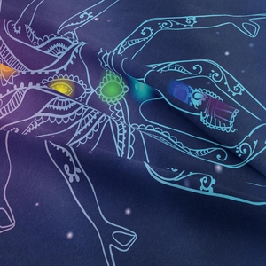 Detail showing soft fabric texture and colorful chakra meditation print on the tapestry