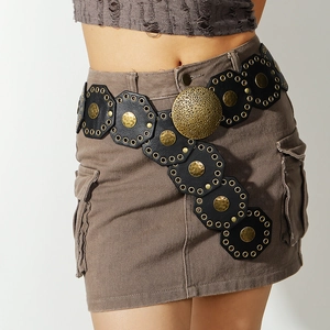 Detail of vintage Western waist belt with large hammered gold buckle and metal studs