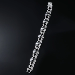 Macro shot of silver skull bracelet with crystal-inlaid Cuban links and clasp