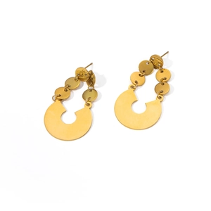 Macro detail of gold irregular circular discs and C-shaped geometric pendant earrings