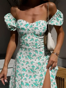Detail of floral off-shoulder dress with puff sleeves and a high side slit for summer