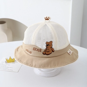 Detail of baby sun hat with breathable mesh fabric and cute bear embroidery on the brim