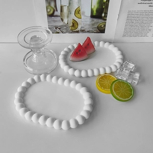 Macro detail of white beaded oval tray coasters made of silicone resin for DIY crafts
